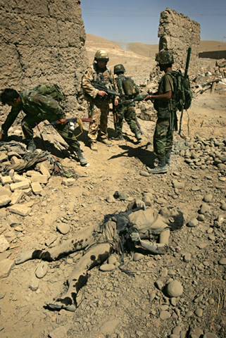 ANA and British soldiers recover the bodies of Taliban fighters buried in rubble after air support is called in.